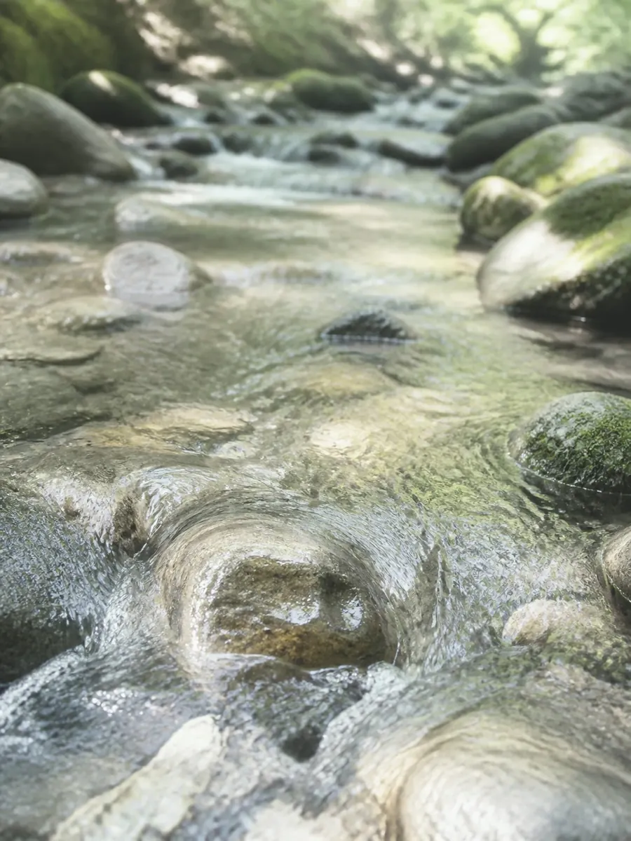 Clear mountain stream water over wet stones in Iga